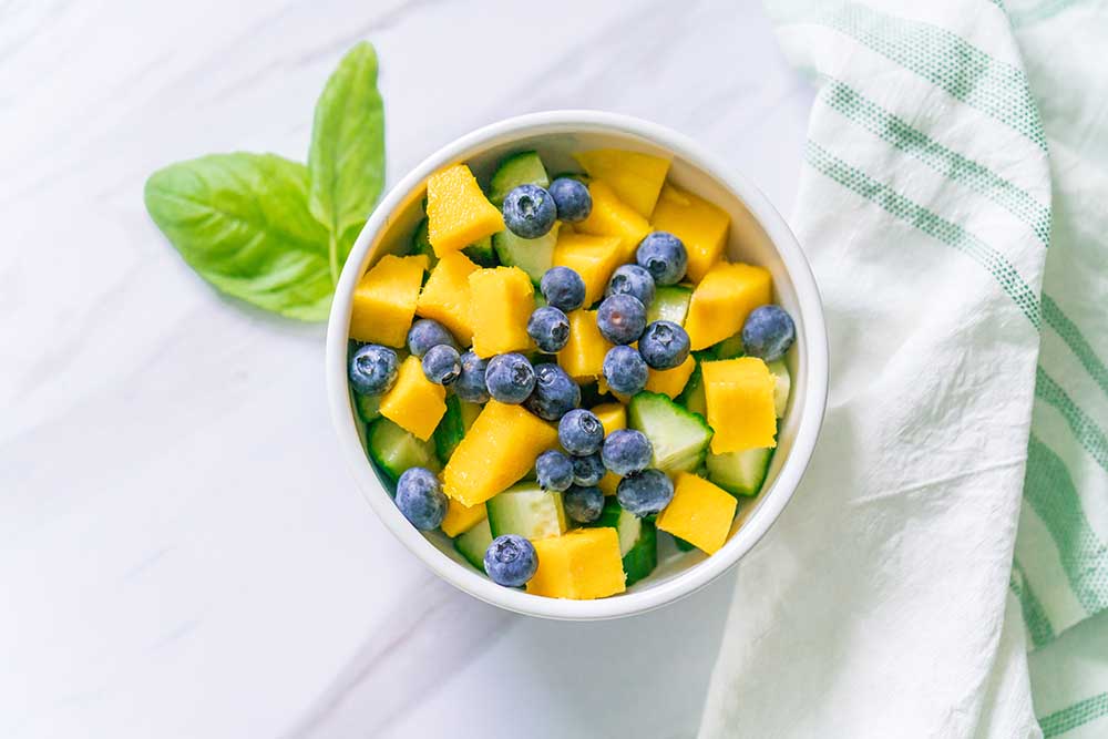 Bowl of Mangos, blueberries, and cucumbers